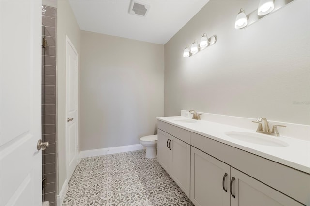 bathroom featuring dual vanity, tile flooring, and toilet