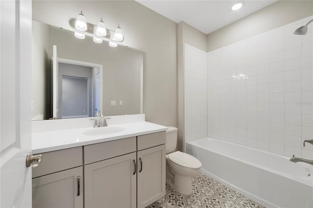 full bathroom with tiled shower / bath, toilet, vanity with extensive cabinet space, and tile flooring