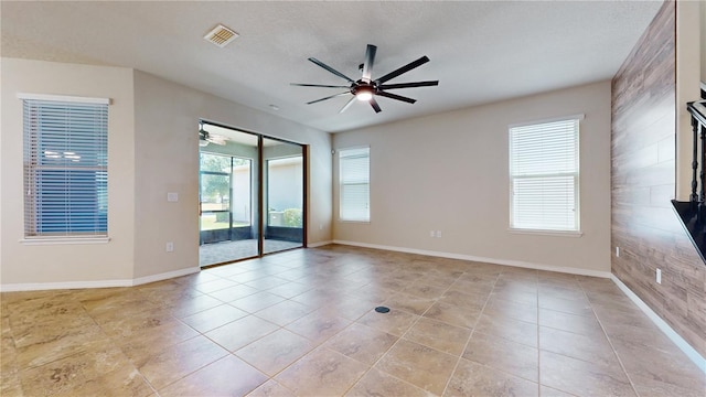 tiled spare room with a textured ceiling