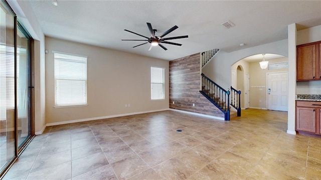 unfurnished living room with ceiling fan