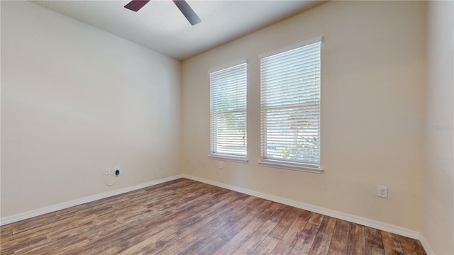 spare room featuring ceiling fan, wood-type flooring, and plenty of natural light