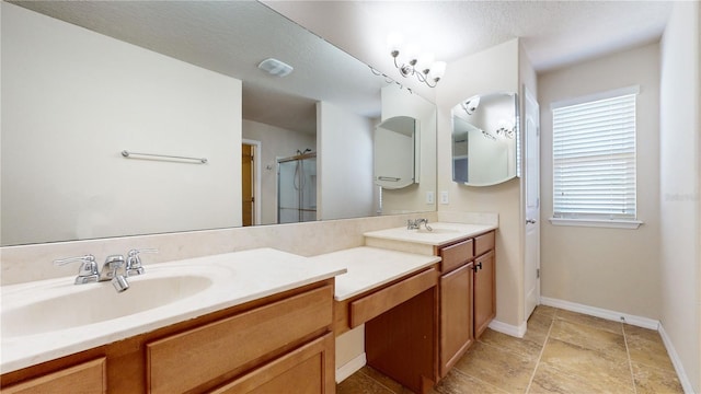 bathroom with a textured ceiling, a shower with shower door, and vanity