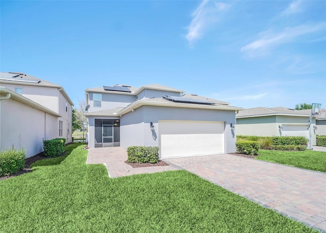 view of front of home featuring a front lawn, a garage, solar panels, and a sunroom