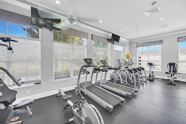 gym featuring ceiling fan and crown molding