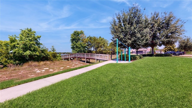 surrounding community featuring a lawn and a playground