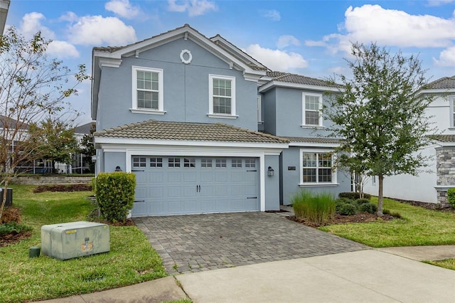 front facade with a front yard and a garage