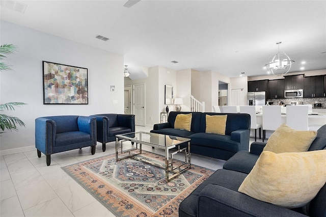 living room with a notable chandelier and light tile floors