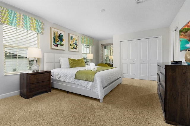 carpeted bedroom with a closet