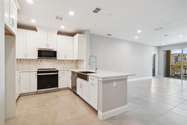 kitchen with white cabinets, kitchen peninsula, and appliances with stainless steel finishes