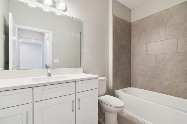 full bathroom with vanity, toilet, and tiled shower / bath