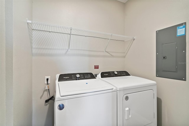 washroom with washer and clothes dryer and electric panel