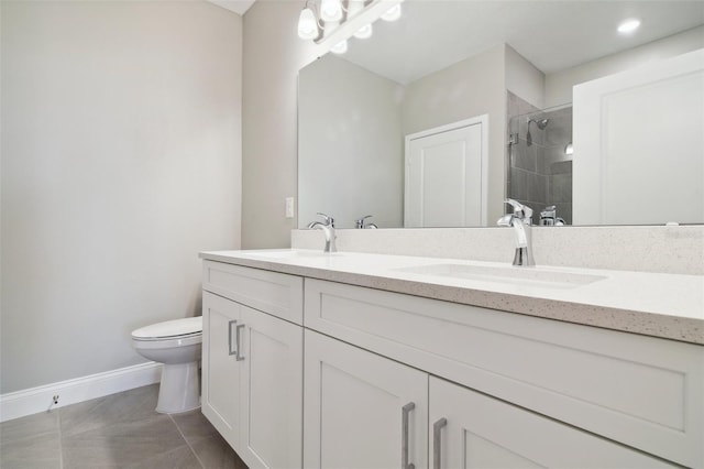 bathroom featuring tile patterned floors, toilet, vanity, and walk in shower