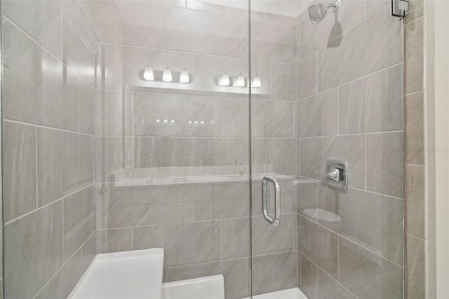 bathroom with a shower with shower door