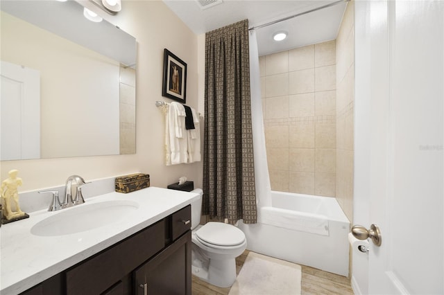 full bathroom featuring shower / tub combo with curtain, toilet, and vanity