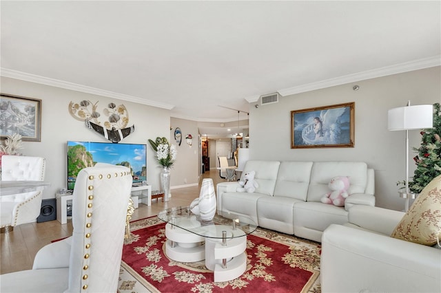 living room featuring ornamental molding and wood-type flooring