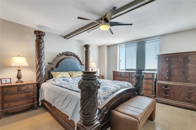 bedroom featuring light hardwood / wood-style flooring, beam ceiling, and ceiling fan