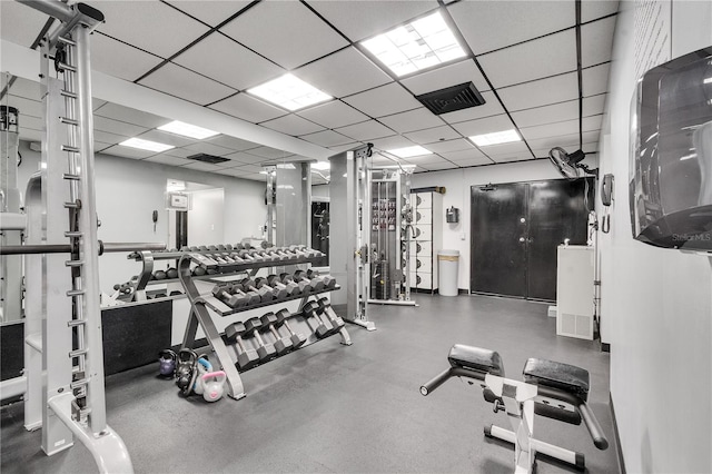 workout area featuring a paneled ceiling