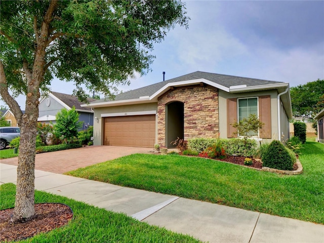 ranch-style house with a garage, stone siding, decorative driveway, and a front yard