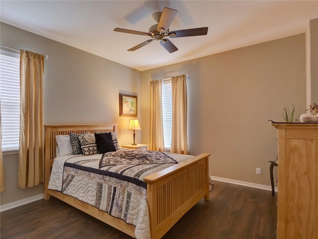 bedroom with ceiling fan, wood finished floors, and baseboards