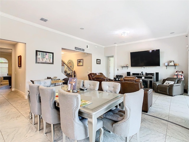 dining space featuring crown molding and light tile floors