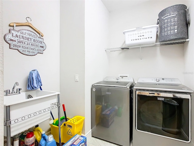 clothes washing area with washing machine and clothes dryer