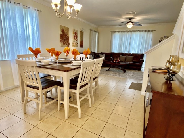 dining space featuring ornamental molding, ceiling fan with notable chandelier, and light tile floors