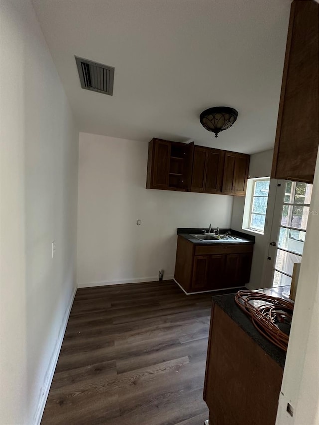 kitchen with dark wood-type flooring, sink, and french doors