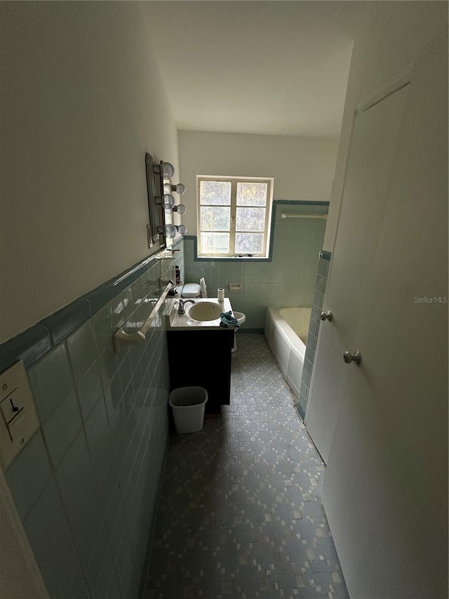 bathroom with tile walls, backsplash, a bath to relax in, tile floors, and vanity