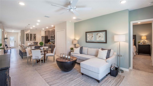 tiled living room with ceiling fan