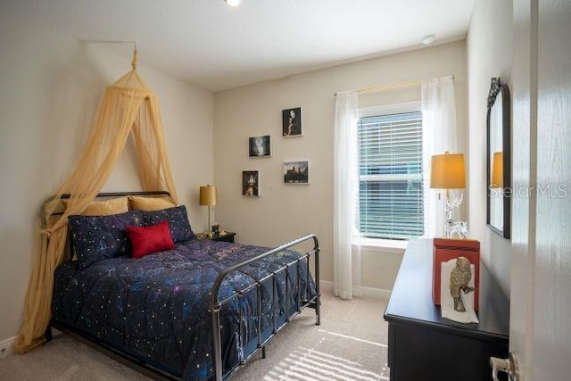 bedroom featuring light carpet