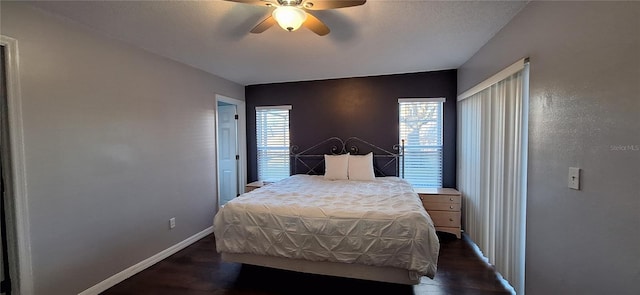 bedroom with ceiling fan and dark hardwood / wood-style floors