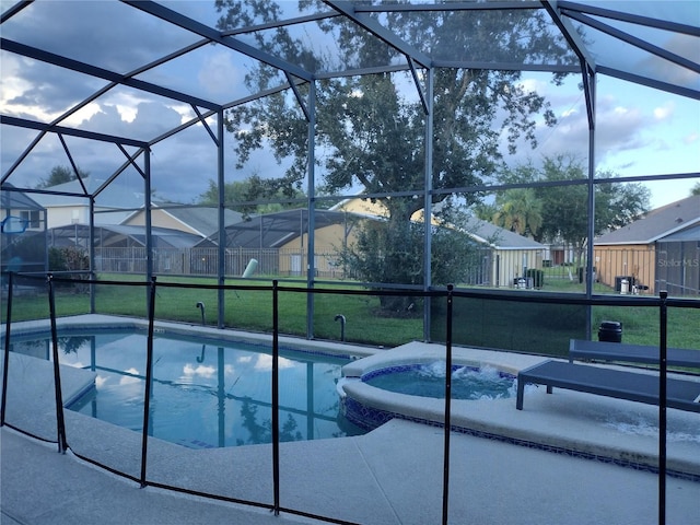 view of swimming pool featuring an in ground hot tub, a yard, and glass enclosure