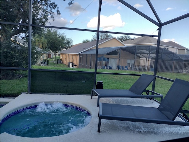 view of patio featuring a lanai and a jacuzzi