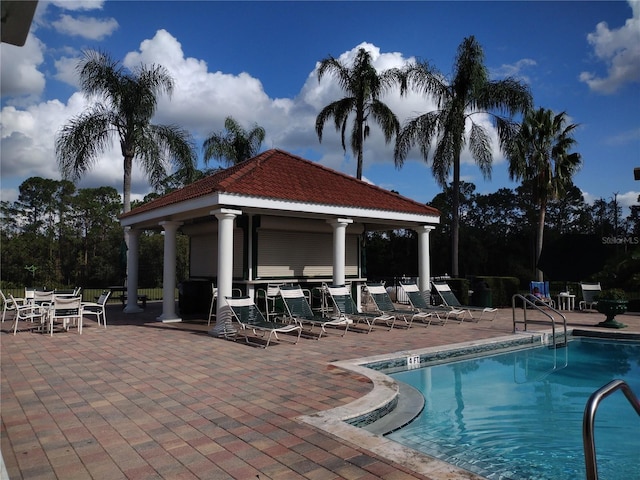 view of swimming pool featuring a gazebo and a patio