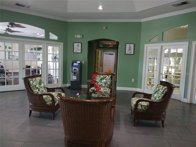 living area with french doors and ornamental molding