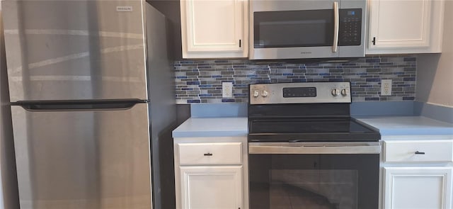 kitchen featuring white cabinetry, tasteful backsplash, and stainless steel appliances