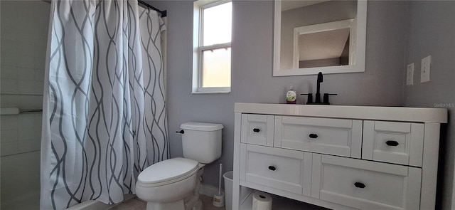 bathroom featuring vanity, curtained shower, and toilet