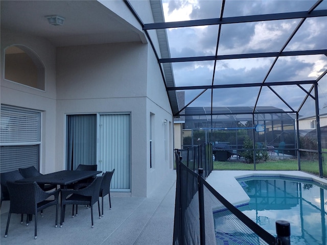 view of swimming pool with glass enclosure and a patio area