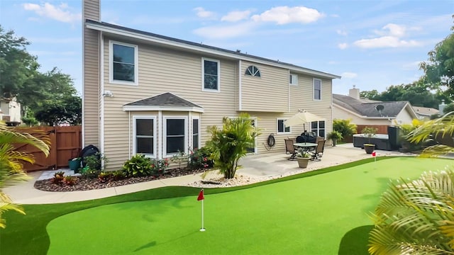 rear view of property featuring a patio area