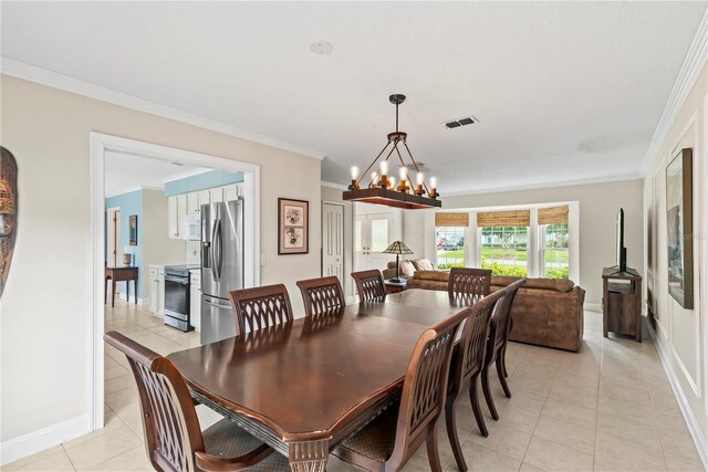 dining space featuring crown molding, light tile floors, and a chandelier