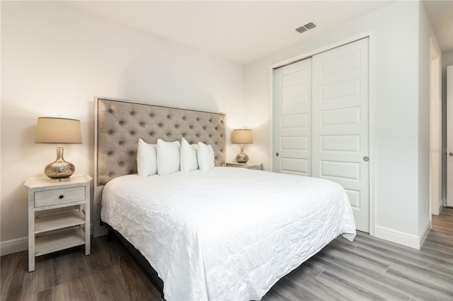 bedroom featuring a closet and dark hardwood / wood-style flooring