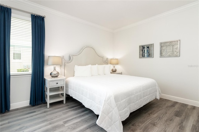 bedroom with baseboards, ornamental molding, and wood finished floors