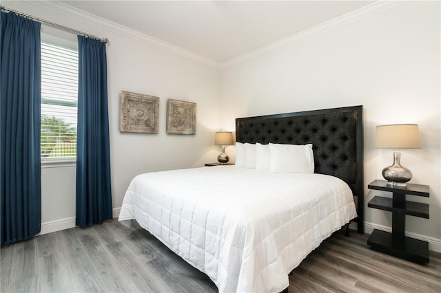 bedroom with crown molding and hardwood / wood-style floors