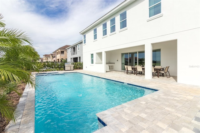 view of pool featuring a patio, outdoor dining area, and a fenced in pool