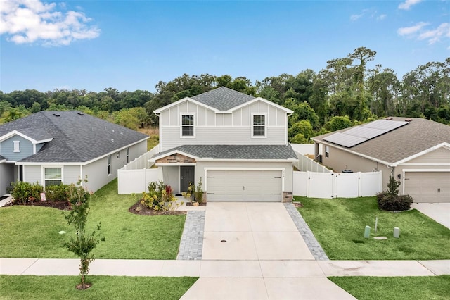 view of front of house featuring a garage, a front lawn, and solar panels