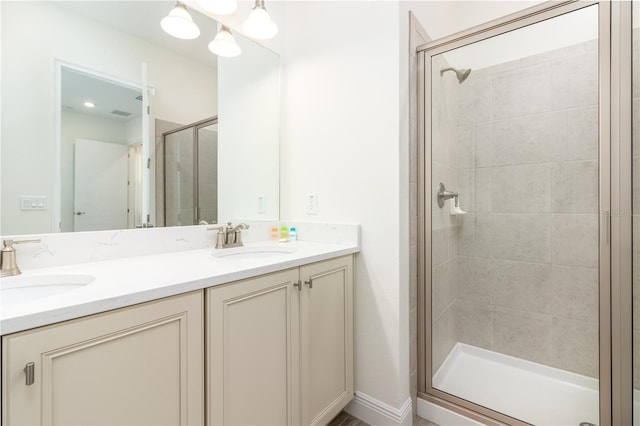 bathroom with an enclosed shower, double sink, and oversized vanity