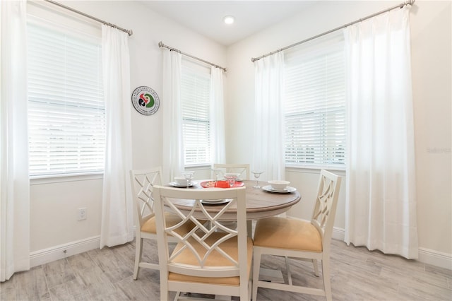 dining space with light hardwood / wood-style flooring