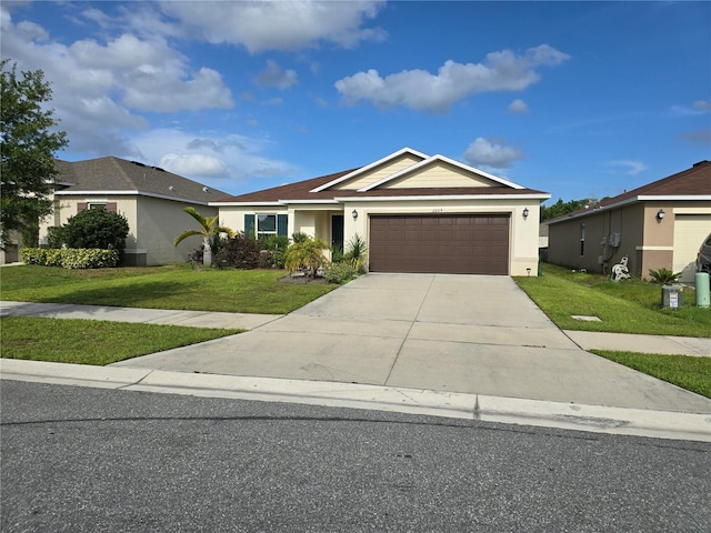 ranch-style home with a garage and a front lawn