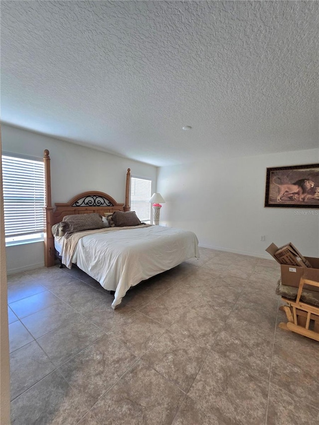 bedroom featuring tile flooring and a textured ceiling