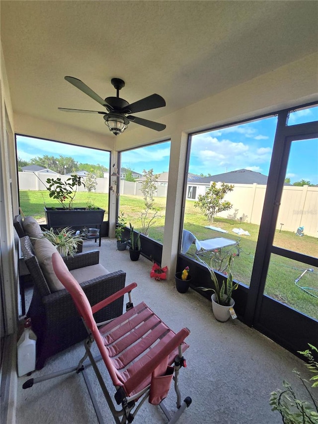 sunroom / solarium with ceiling fan and a healthy amount of sunlight